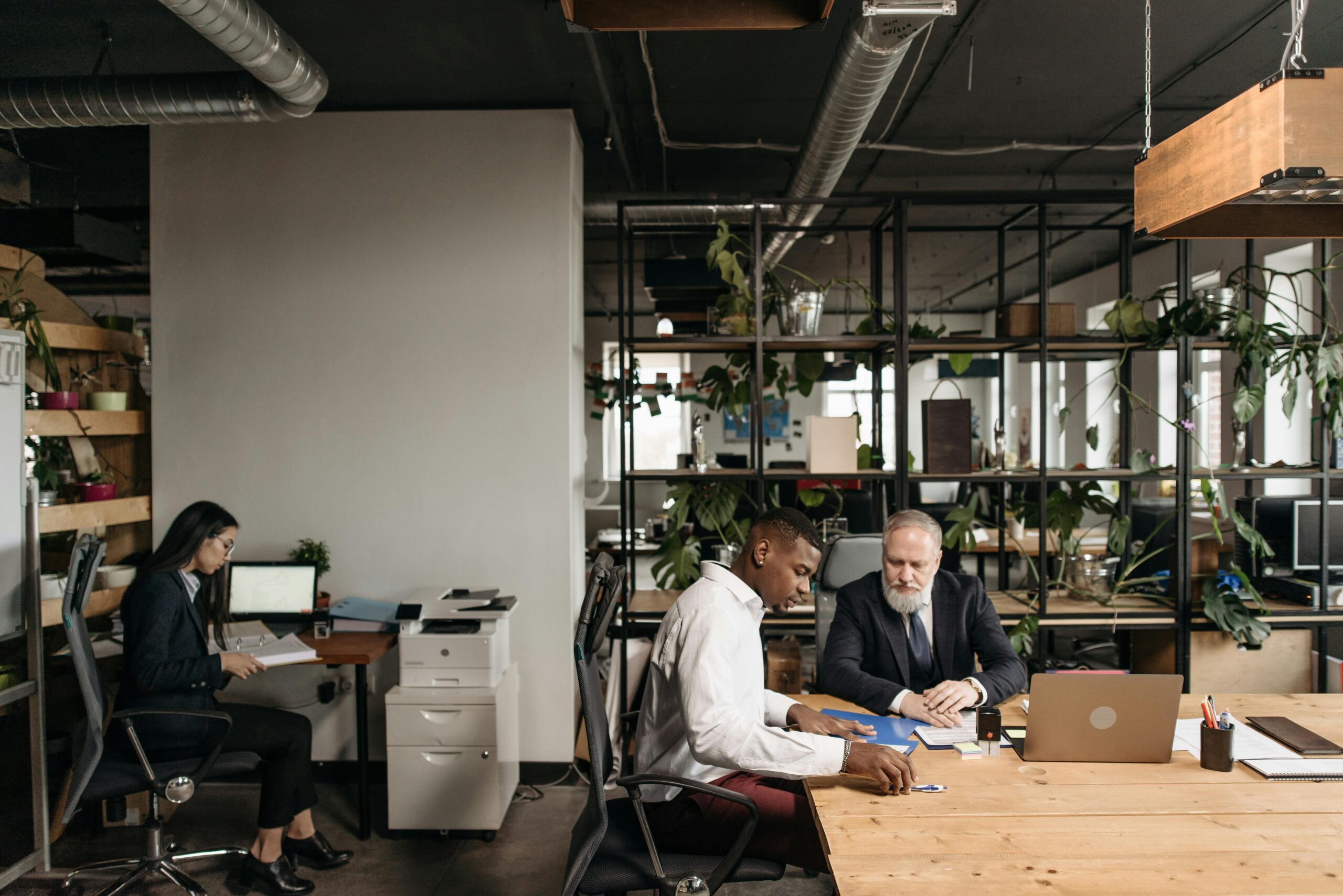 Diverse team engaged in a meeting in a modern open office environment.